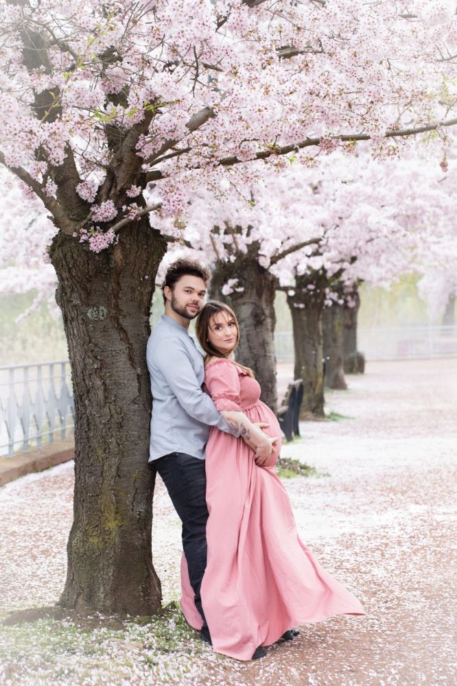 Schwangerschaftsfotografie Düsseldorf Outdoor – romantisches Babybauchshooting mit Partner unter Kirschblütenallee im Frühling